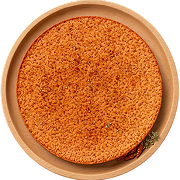 Round, crispy, orange-brown spicy peri peri khakhra on a wooden plate with a small spice garnish.